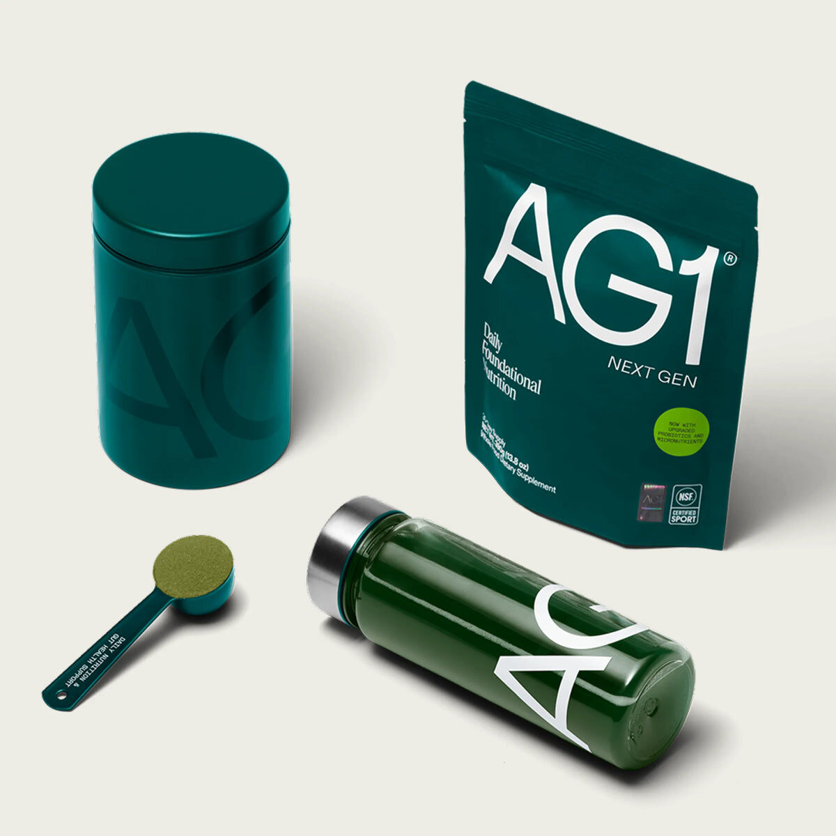 AG1 Next Gen pouch with green canister, scoop, and shaker bottle