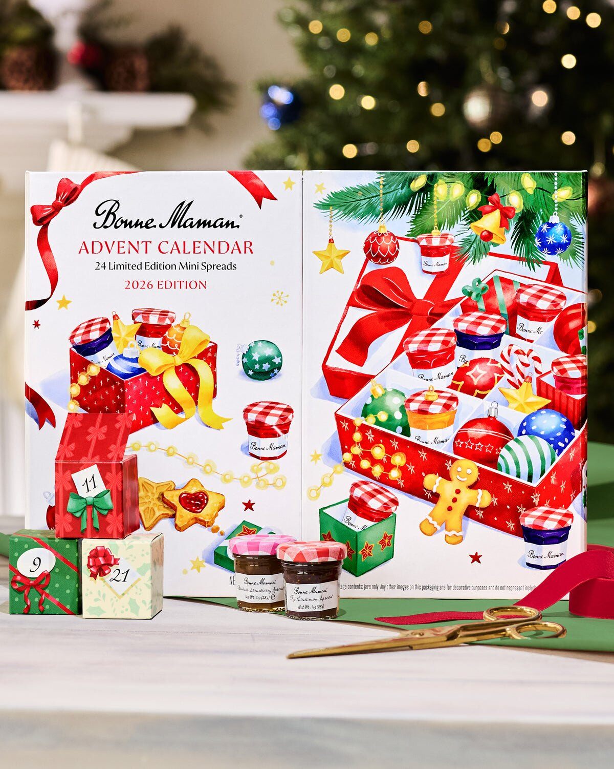 Bonne Maman Advent Calendar 2026 Edition box with mini jam jars and numbered gift boxes by a Christmas tree