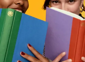 Readers holding colorful Book of the Month hardcovers
