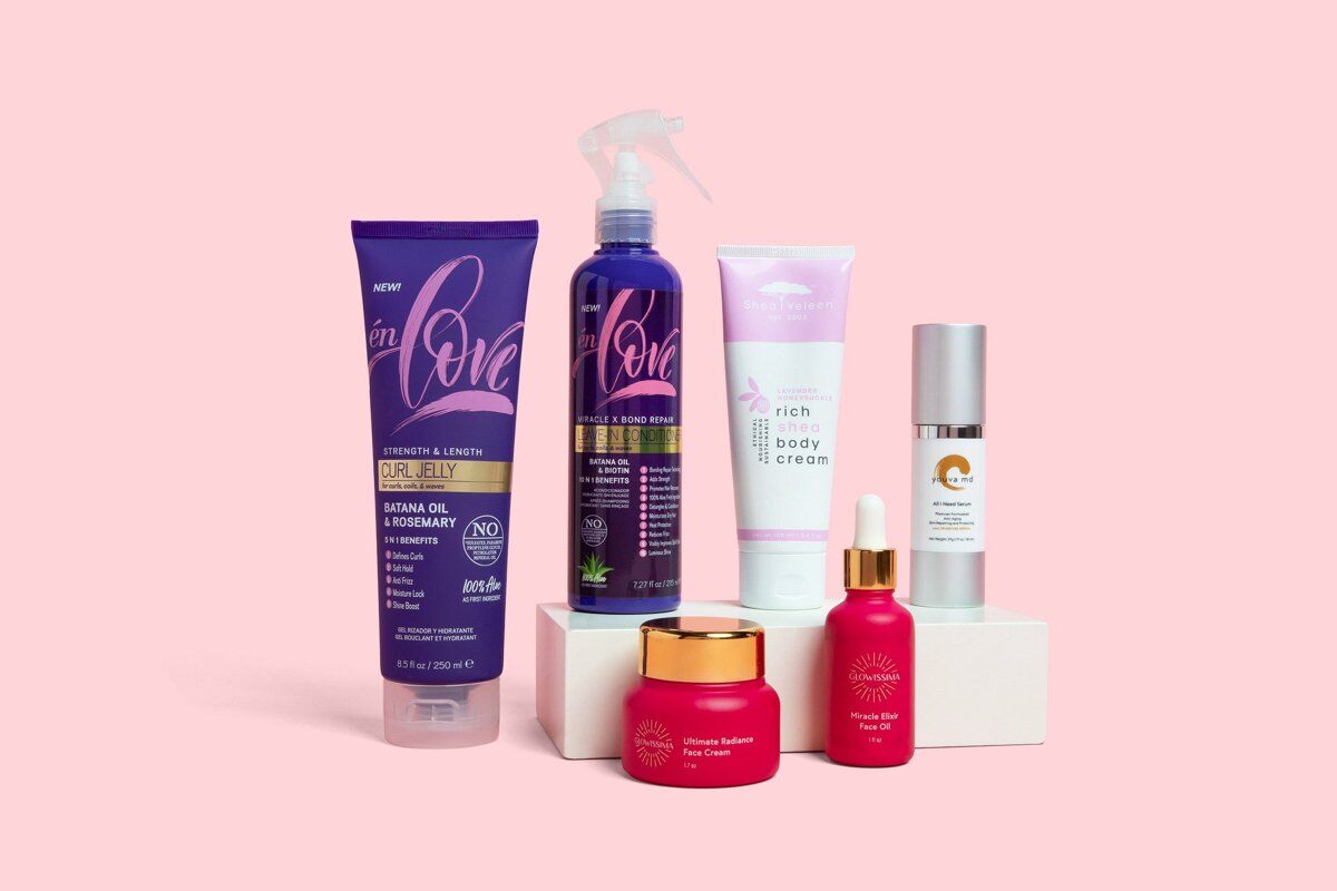 The contents of COCOTIQUE's September 2026 beauty box, its final monthly box, on a pink background