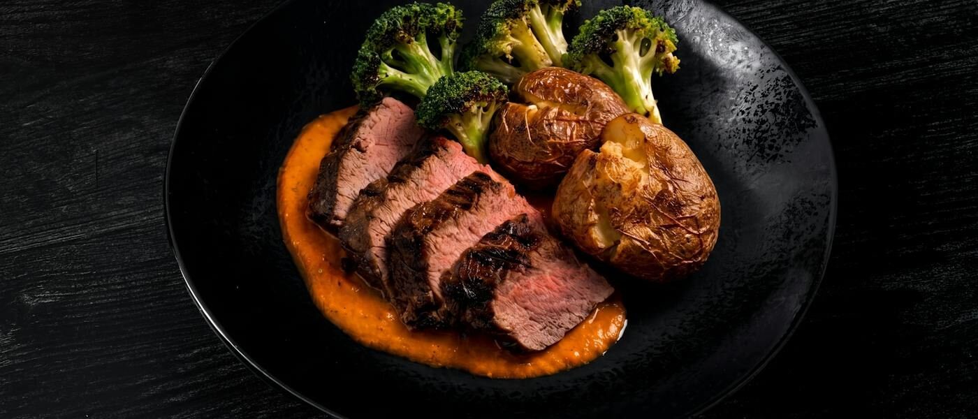 CookUnity steak dinner plated on a dark dish