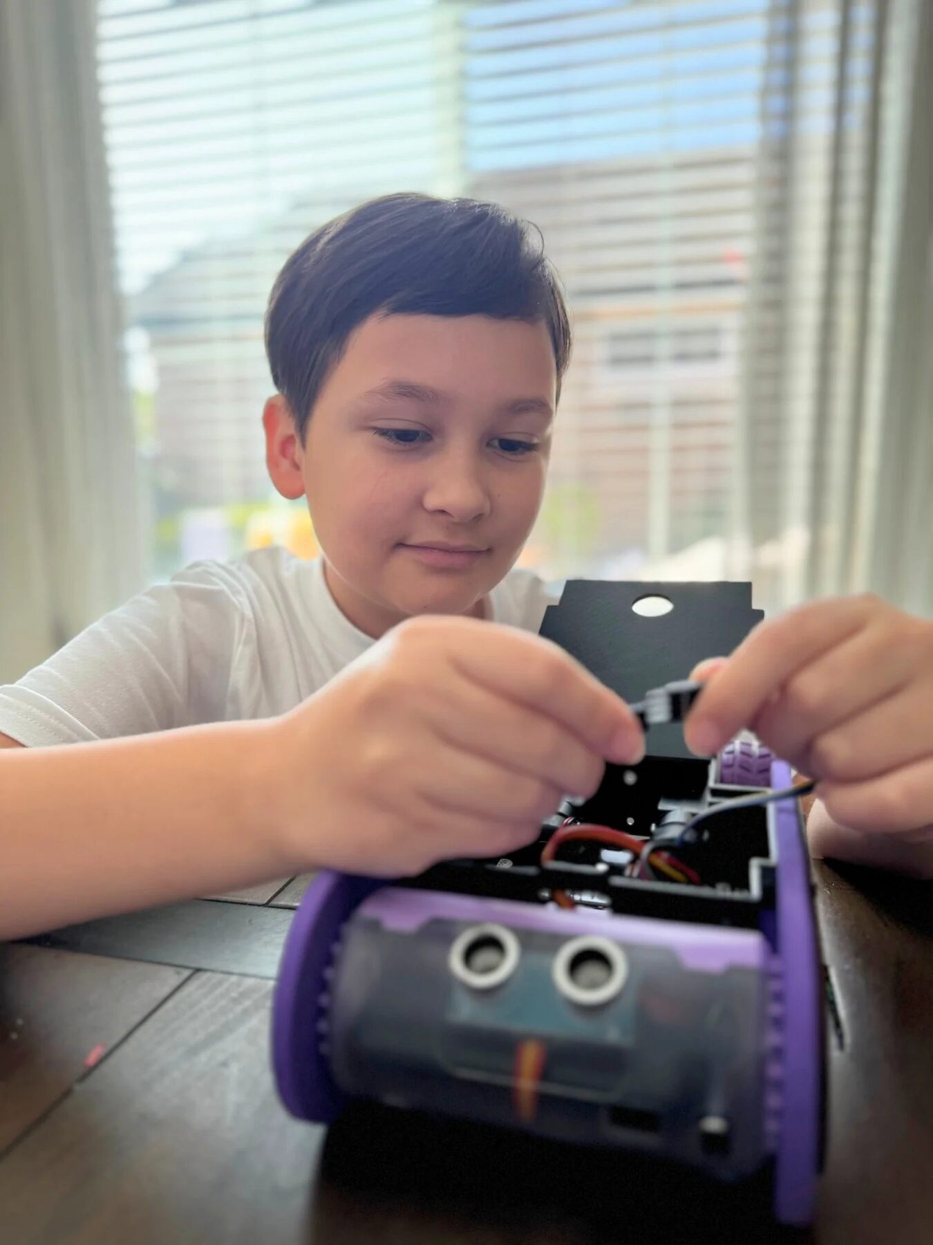 Teen building a CrunchLabs Hack Pack project