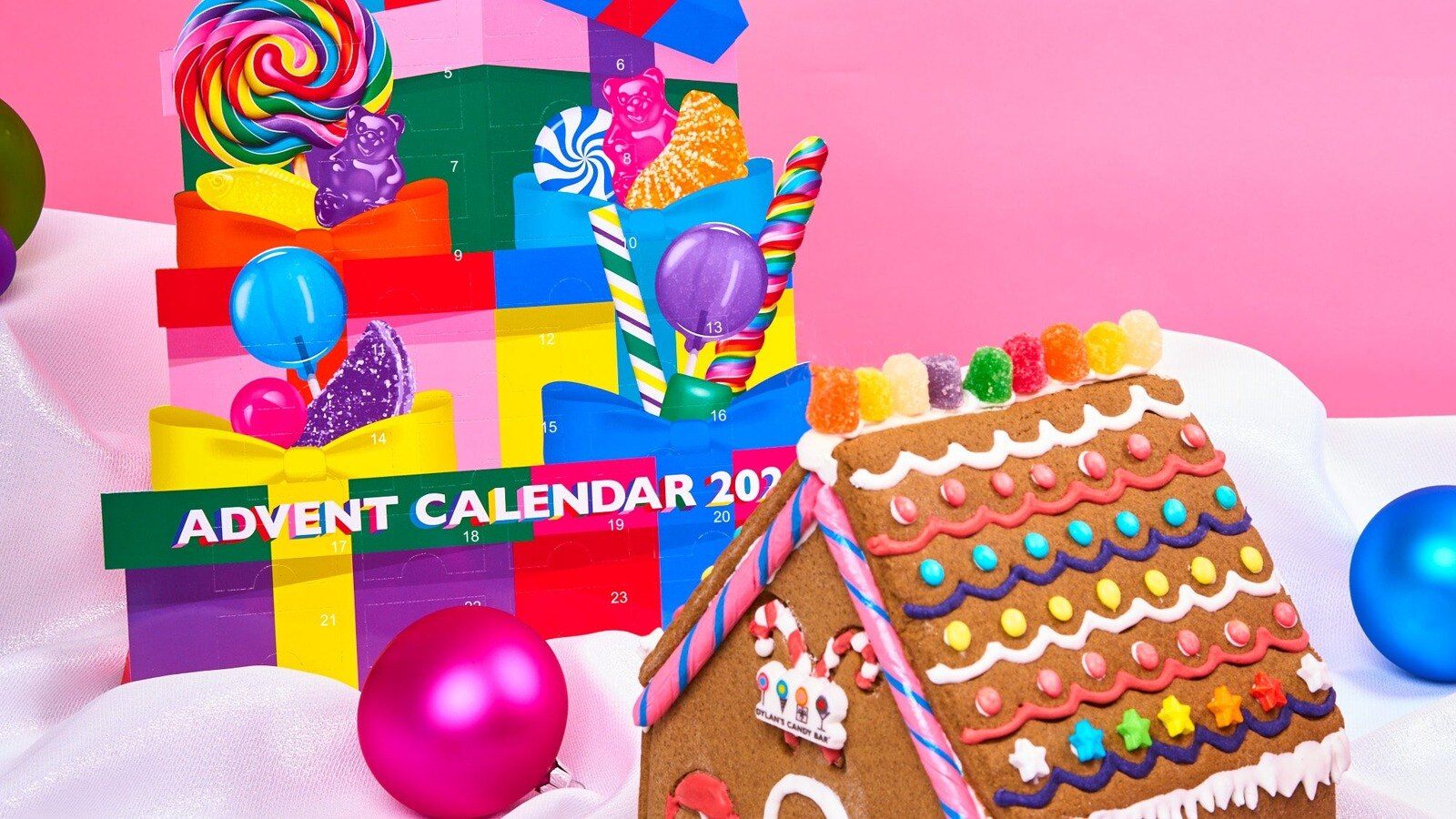 Dylan's Candy Bar 2026 Advent Calendar shaped like a stack of presents next to a gingerbread house