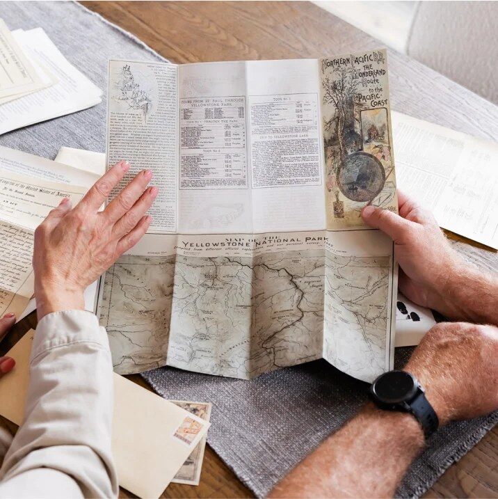 Reader unfolding a replica letter