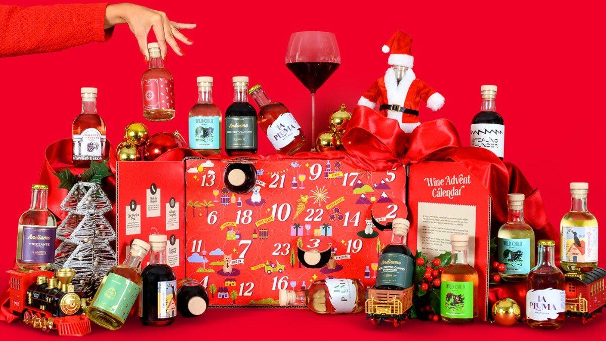 In Good Taste 2026 Wine Advent Calendar surrounded by its mini wine bottles on a red background