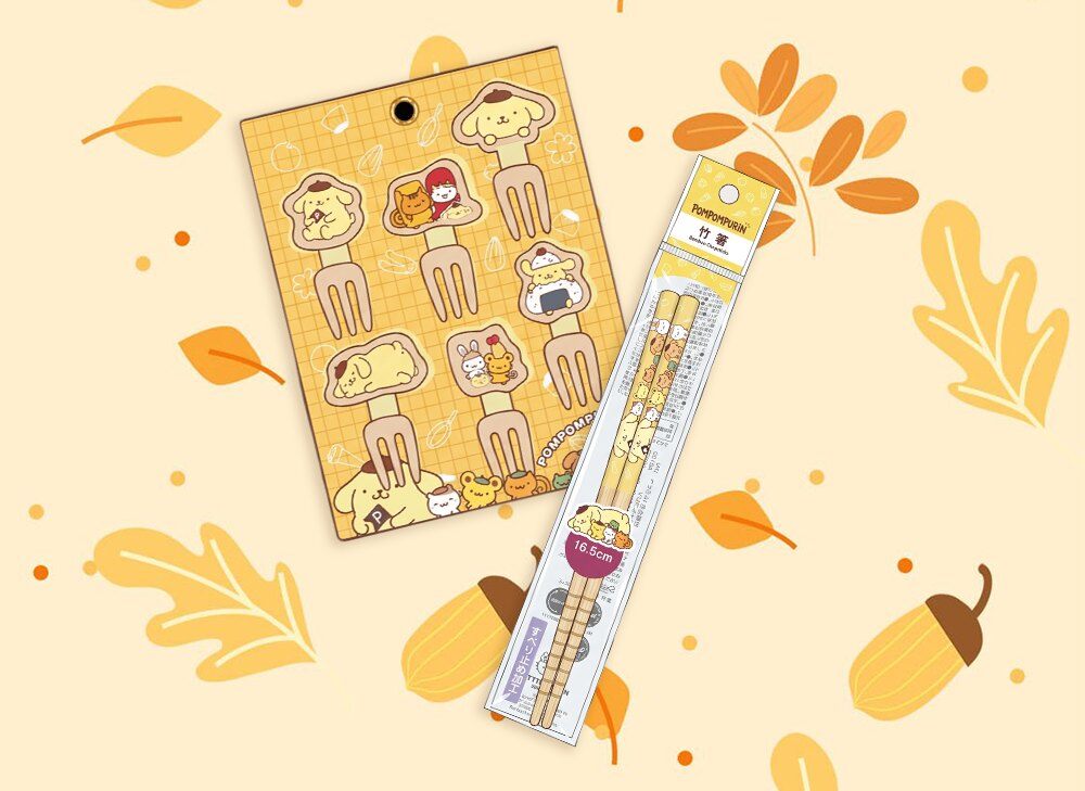 Pompompurin mini fork picks and bamboo chopsticks from the Kawaii Box November 2026 on an autumn leaf background