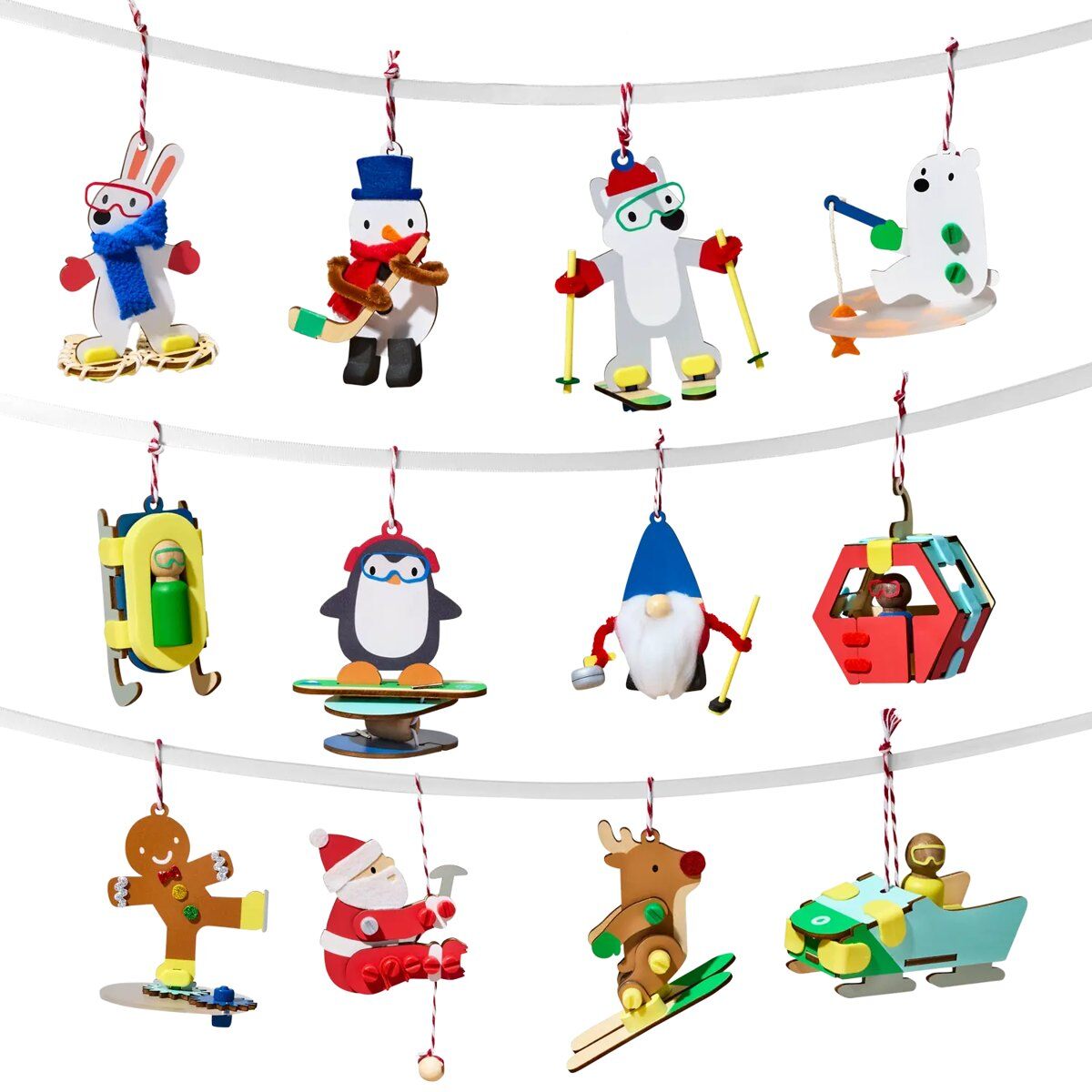 Twelve winter sports ornaments from the KiwiCo Snowy Sports Ornaments Advent Calendar hanging on garlands