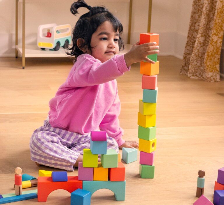 Toddler stacking Lovevery blocks