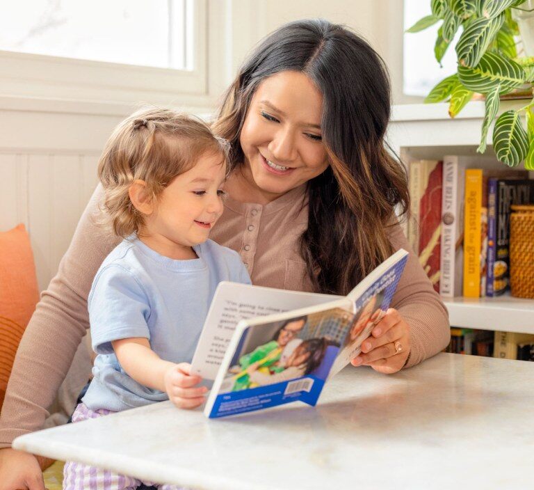Parent reading a Lovevery book with a child