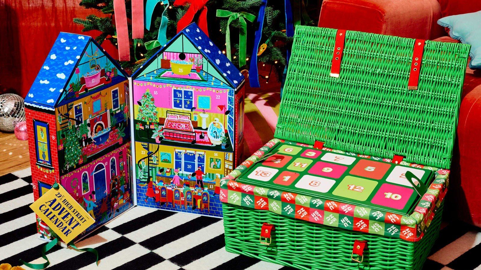 Lush 2026 Advent Calendar green wicker hamper next to the 29 1/2 High Street Advent Calendar house box under a Christmas tree