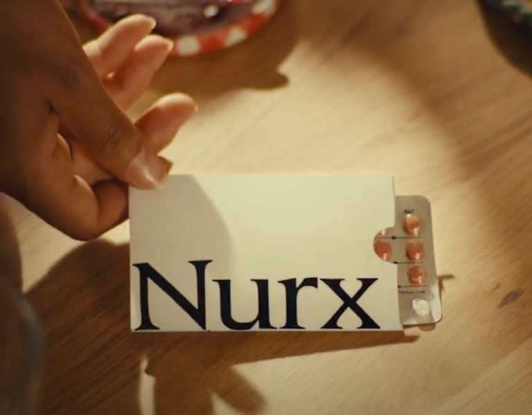 Hand holding a Nurx birth control pill pack