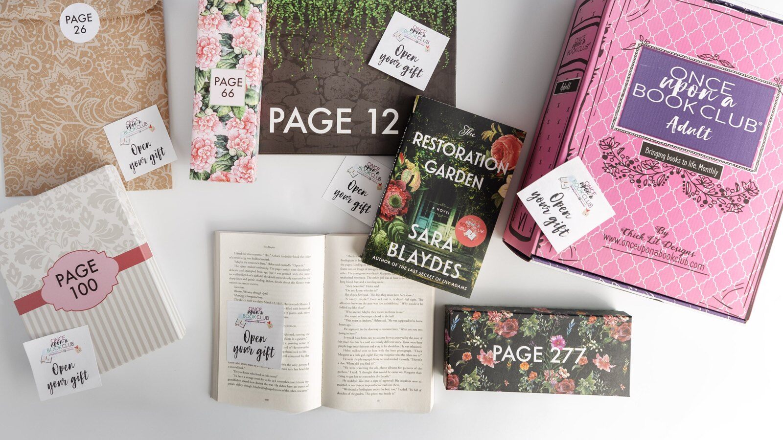 An opened Once Upon a Book Club Adult box with a novel and wrapped gifts labeled with page numbers