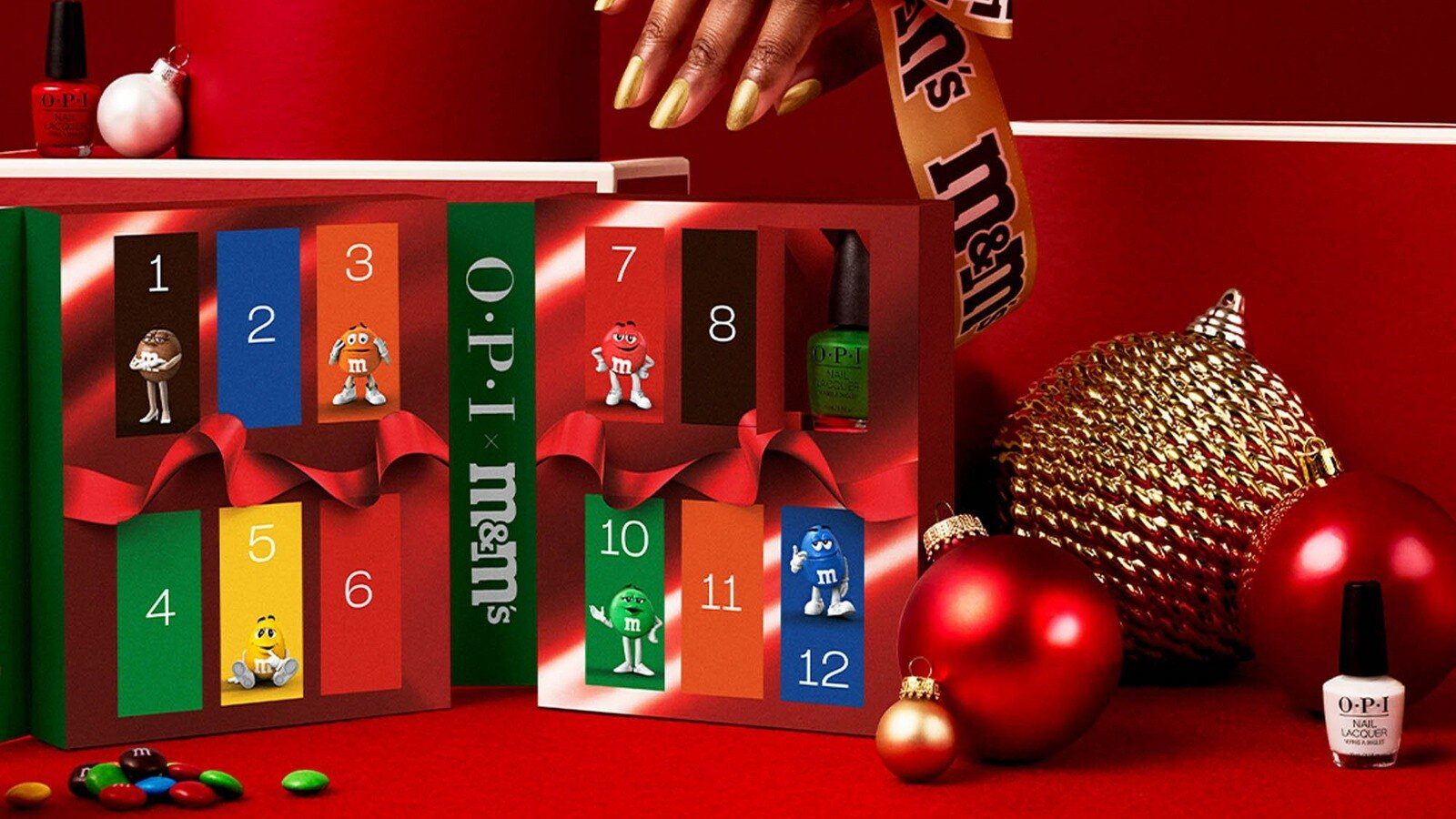 OPI x M&M'S Holiday Collectible 12 Piece Advent Calendar with numbered M&M'S doors, nail polish and red ornaments