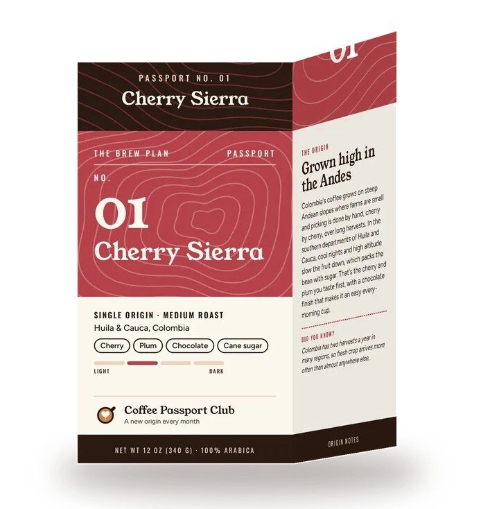 A Coffee Passport Club box by The Brew Plan, No. 01 Cherry Sierra, with a red topographic design, tasting notes and the origin story printed on the side