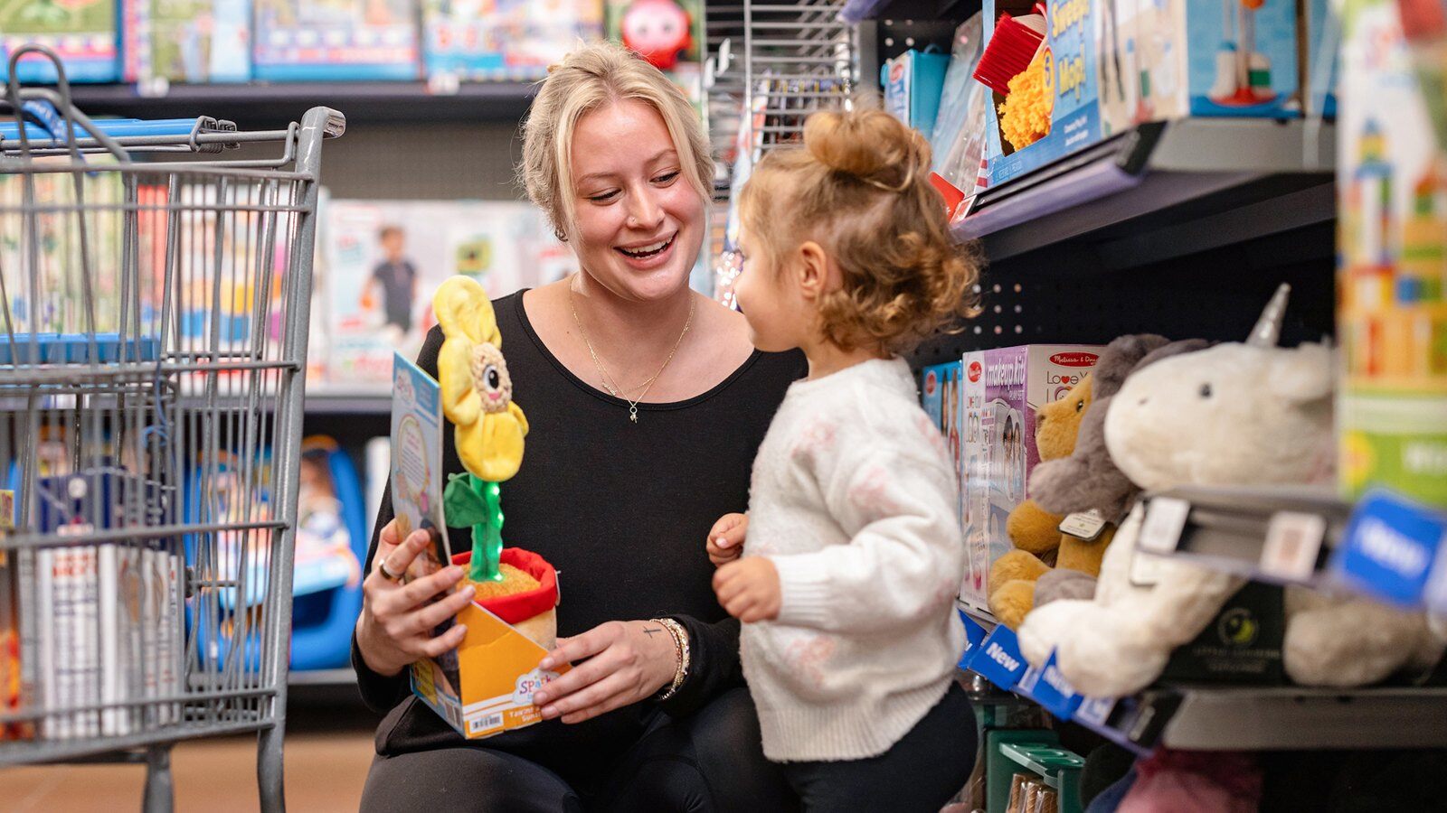 Mother and child shopping the toy aisle at Walmart for the 2026 holidays